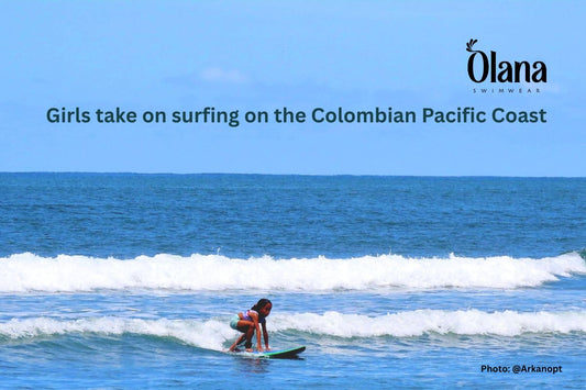 A girl stands up on a surfboard